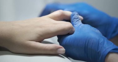 Manikürcü, müşteri tırnaklarını cilalıyor ve kuaför salonunda cilalıyor. Güzel tırnak şekli konsepti