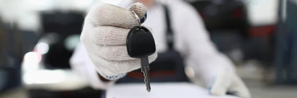 自動車サービスの従業員は手とクリップボードにキーを保持します 機械は仕事の概念に歓迎される — ストック写真