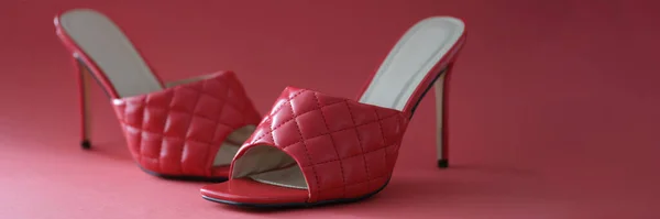 Pink slippers with heels on a pink background, close-up. Photo area for shooting shoes in the studio, shop window