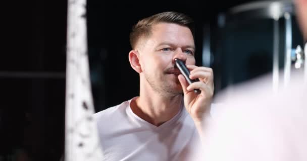 Handsome Young Man Removes Hair Nose Trimmer Front Mirror Nose — Vídeo de stock