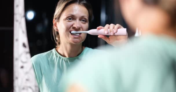 Woman Brushes Teeth Electric Toothbrush Front Mirror Oral Hygiene Dental — Vídeo de stock