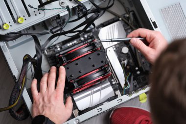 Repairman works with screwdriver and repairs computer equipment. Service maintenance of computer equipment concept