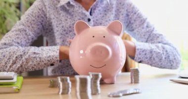 Insurance agent woman holds hands on piggy bank. Protection and security of financial and banking savings concept