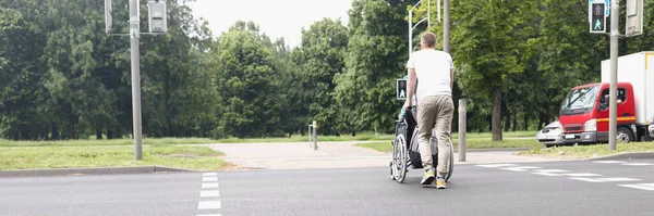 Sudut Rendah Pria Mengendarai Wanita Kursi Roda Seberang Jalan Penyeberangan — Stok Foto
