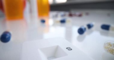 Express Covid 19 test and capsules lie on the table, close-up, elevated view. Medical tools for diagnosing a disease