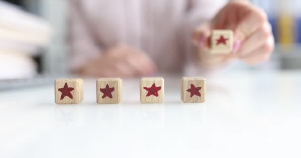 Womans Hand Puts Wooden Cubes Row Table Stars Close Concept — Video Stock