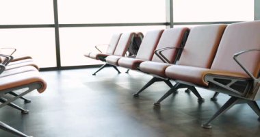 Empty room with leather chairs in a row, close-up, shallow focus. Modern waiting room furniture, terminal