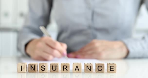 Wooden Cubes Inscription Insurance Agents Desk Close Shallow Focus Insured — Vídeo de Stock