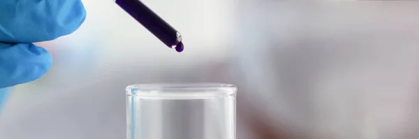 Close-up of chemist conducts analysis of water samples versions of reagents using chemical manufacturing, testing in laboratory. Chemistry, lab concept
