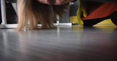 Cleaner takes sock out from under bed. Cleaning services concept