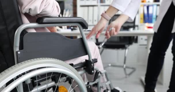 Doctor Taps Knee Patient Wheelchair Hammer Numbness Lower Extremities Legs — 图库视频影像