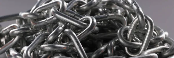 Chrome plated metal chain on gray background. Strong metal chain chain links concept