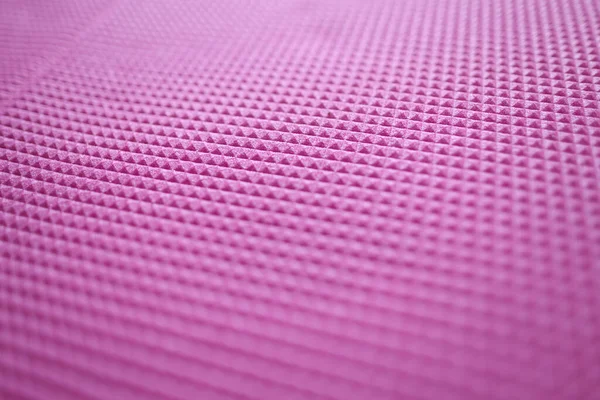 Pink texture of a sports mat and rubber pattern for background. Pink texture in rhombuses concept
