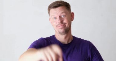 Young man waving at camera and calling you on white background 4k movie. Profitable job offer concept