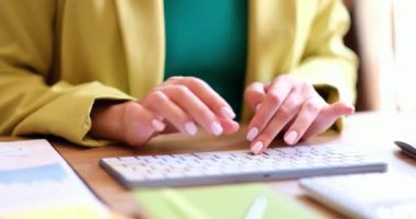 Business woman using laptop computer for work and searching for information at table. Female hands typing on laptop keyboard and learning how to work with computer technology