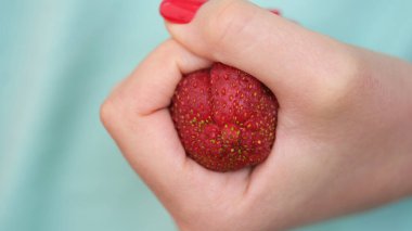 Clenched strawberries in fist in form of constipation of colon. Hemorrhoids acute symptoms and treatment