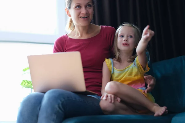 Portrait Mother Child Sitting Sofa Laptop Looking Away Surprise Emotions — Zdjęcie stockowe