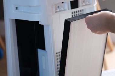 Replacing the filter in air conditioner and outdoor air purifier. Purifier filters and portable air conditioner