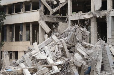 Destroyed cement building warrior rocket strike or earthquake. Explosion or destruction of buildings concept