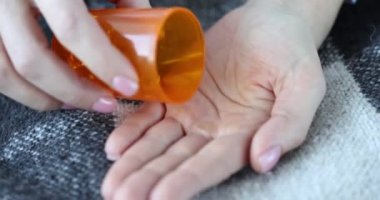 Person hand taking medicine from omega 3 bottle. Take daily dose of tablets or vitamin d nutritional supplements and immune or antiviral drugs