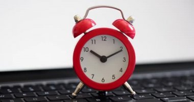 Alarm clock for ten oclock on laptop concept for business timetable deadline and urgency. Working hours search for information on the Internet and control time on Internet