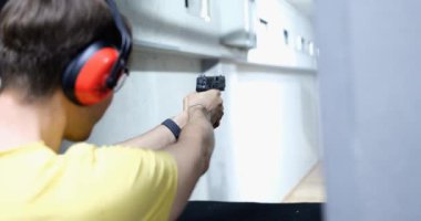 Professional train in shooting from a pistol in shooting range. Police and military gun training