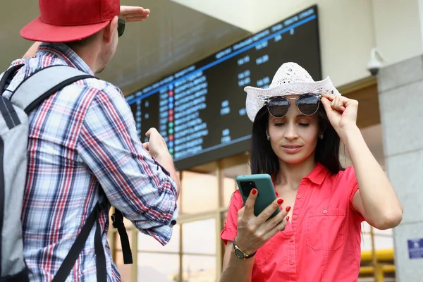 Man Woman Tourists Mobile Phone Background Electronic Board Bus Railway — Stock Photo, Image