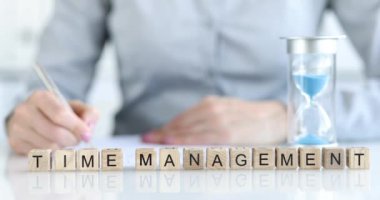 The inscription time management on wooden cubes in the office on the table. Task assessment, prioritization