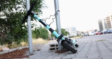 The electric scooter lies on the sidewalk, close-up. Fashionable vehicle, moving around the city, lifestyle