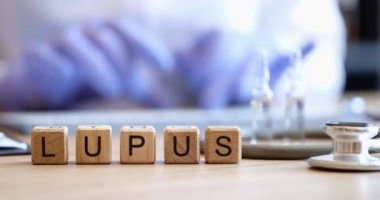 Wooden cubes with the inscription lupus on the doctors table, close-up, shallow focus. Diagnosis of the disease
