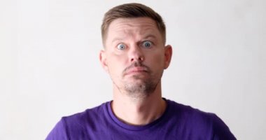 The man opened his mouth in surprise and shook his head, close-up. Stress and shock, negative emotions on the face