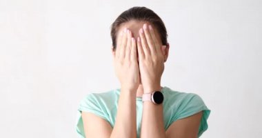 The woman covered her face with her palms, close-up. Pleasant surprise on the face, positive emotions on the face