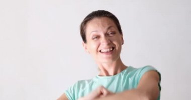 Smiling woman having fun and dancing, close-up. Joyful expression of feelings, positive emotions