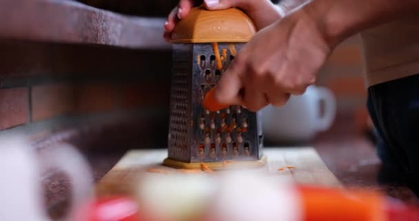Woman Rubs Carrot Grater Close Her Hand Shallow Focus Cooking — Stock video