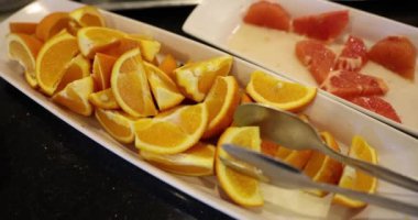 Summer fruit plate with slices of juicy fresh oranges on plate. Delicious and healthy food for vegetarians.