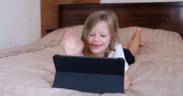 Smiling Girl Child Video Call Tablet Computer Lying Bed Home — Αρχείο Βίντεο