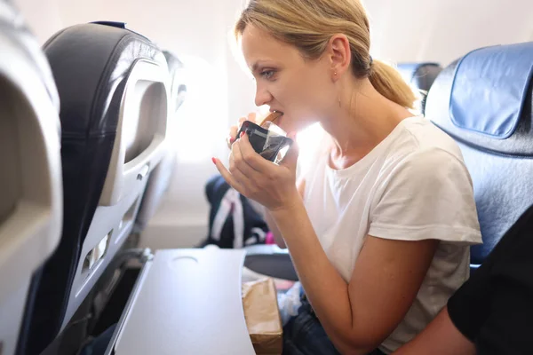 Woman Eats Juicy Tasty Sandwich Cabin Airplane Flight Catering Concept — Foto de Stock