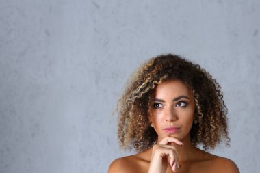 Portrait of a pensive latino woman looks up mysteriously. Emotions of thoughts and search for new ideas