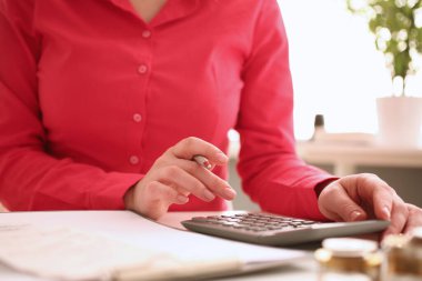 Woman secretary counts on calculator in office closeup. Business budget and company expenses