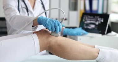 Woman leg ultrasound diagnosis, close-up, slowmotion. Scanning of vessels and veins, medical equipment