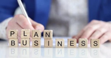 Yazılı iş planı, tahta küpler, yakın çekim, yüzeysel odaklanma. Yönetici özeti, iş kavramı