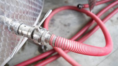 Kırmızı musluk fabrikanın yakınındaki çelik varile bağlı. Kimyasal endüstri konsepti