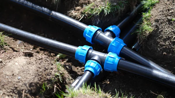Closeup of plastic pipes of plant watering system in gardens. Gardening plant care concept