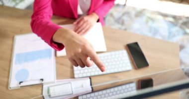 Yönetici, bilgisayar sistemi korumasını test ederken bilgisayar monitöründeki çizelgeleri işaret ediyor. Çevrimiçi veri analizleri