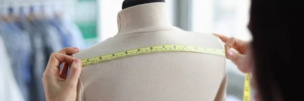 stock image Female tailor takes measurements on mannequin. Atelier for repair and tailoring of stylish clothes concept