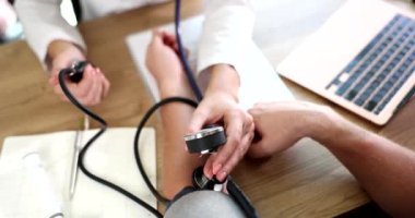 Doktor klinikteki hastanın kan basıncını ölçüyor. Arteriyel hipertansiyon ve basınç dalgalanmaları neden ve tedavi