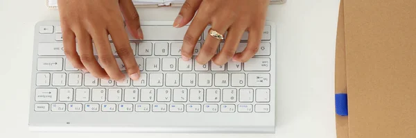 Hands of a black woman on a computer keyboard, close-up. Online education, webinar, training courses