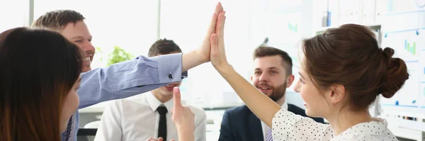 Portrait of colleagues give high five gesture in order to celebrate end of company project, change future of corporation. Goal, success, career concept