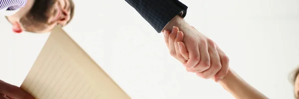 Low angle of partners shake hands over business agreement, successful deal between biz partners. New step in development for corporation. Success concept