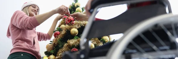 Frau Und Freund Rollstuhl Hängen Rote Weihnachtskugel Neujahrsbaum Vorbereitung Auf — Stockfoto